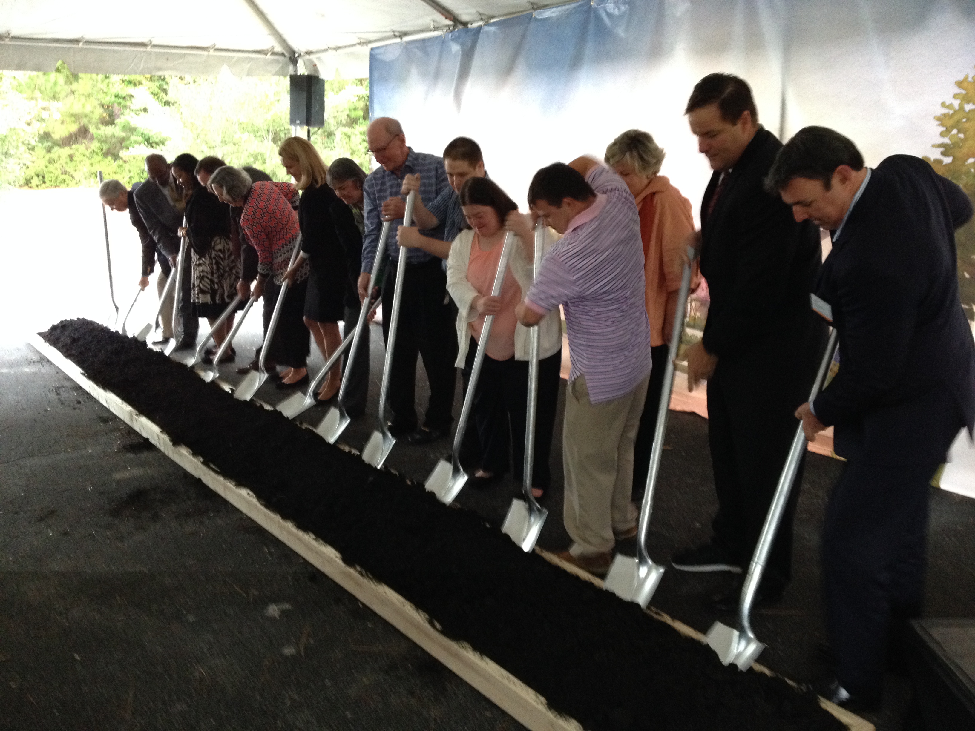 Participants ceremonially turned dirt at the groundbreaking of the Arc Village in Jacksonville.