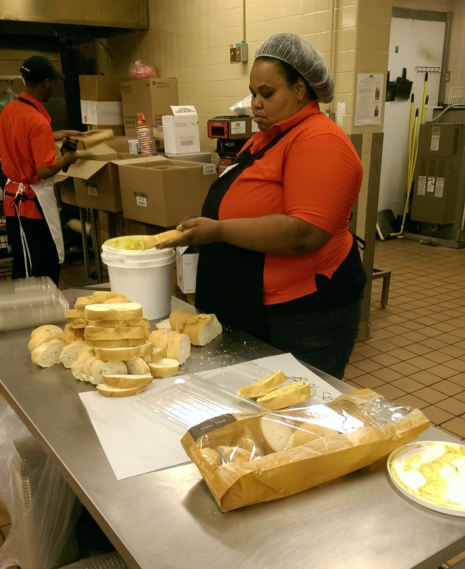 Annie cutting bread for packaging