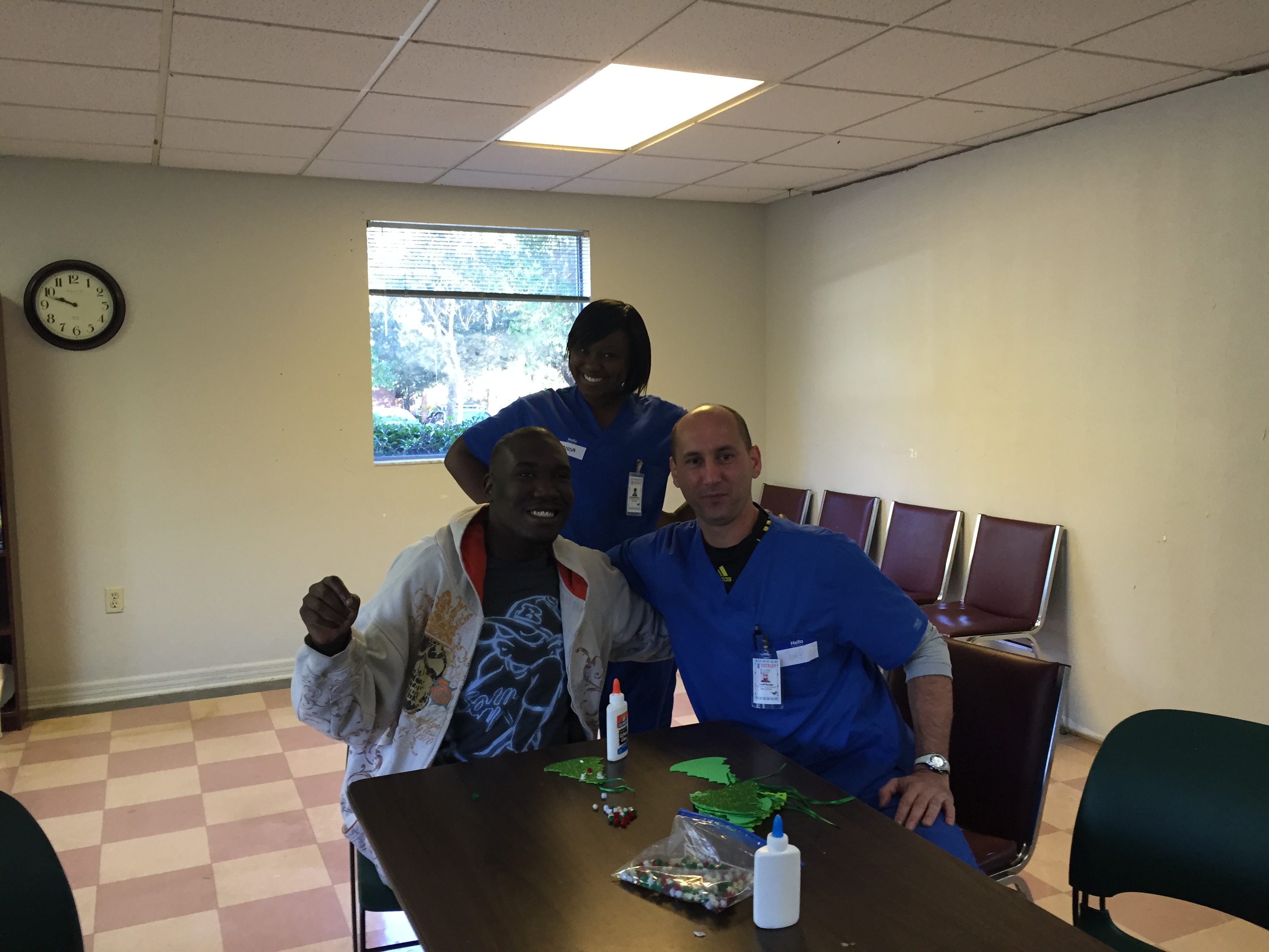 Participant Derek Tinsley (L); volunteer nursing student Josef Kaiser (R) and volunteer nurse Clarissa Charles standing behind them.