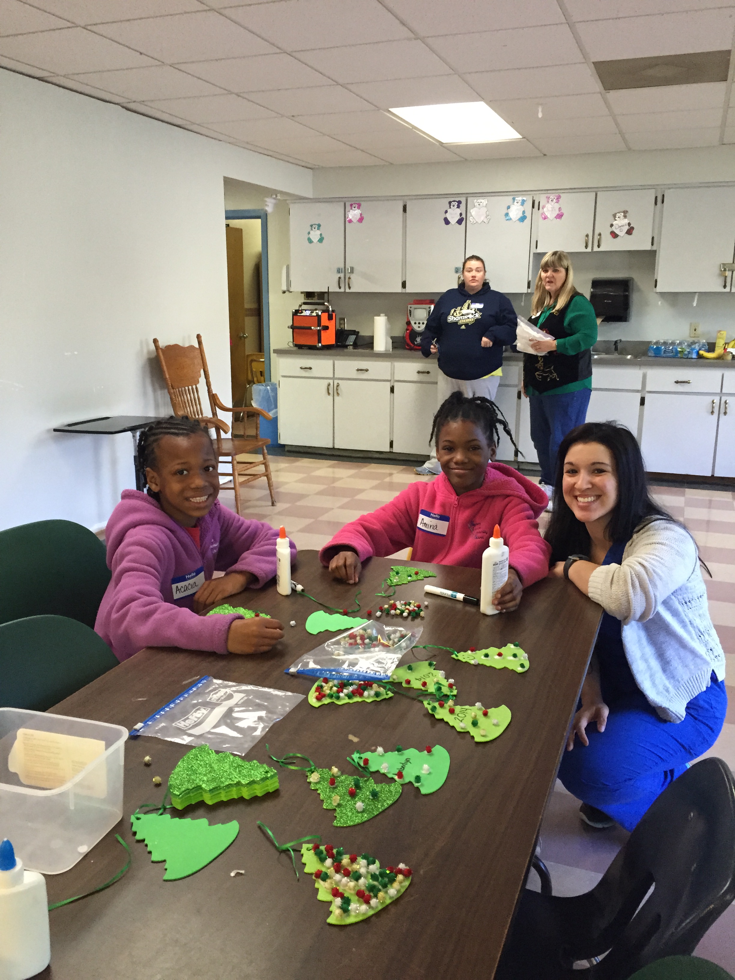 Sisters Acacia and Amiria enjoying arts and crafts with nursing student Emily Wolf. Jenny Gray (on left in background) of Arc and Pam Thompson from Levy County School District watch the girls having fun.  
