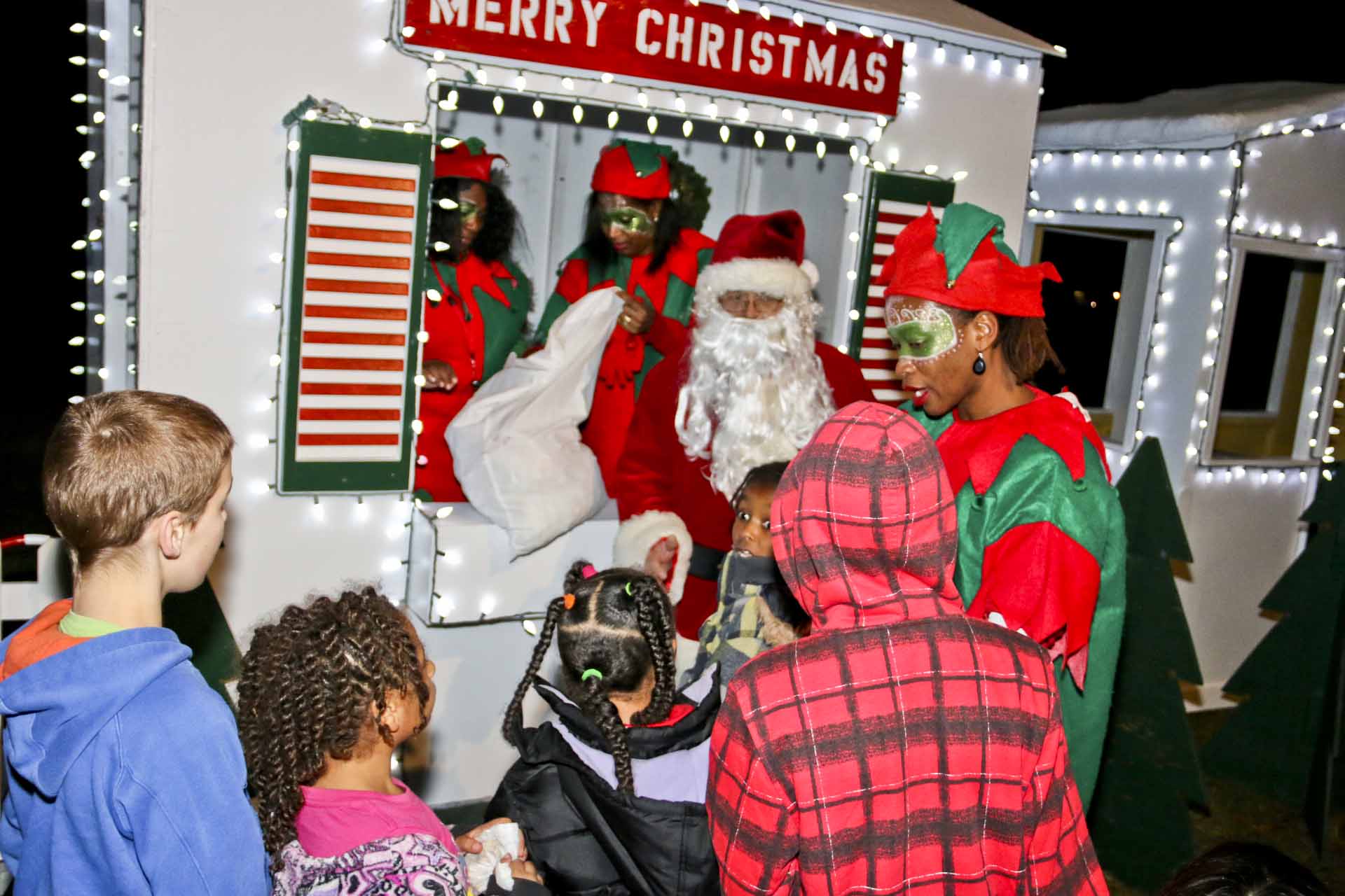 Santa Claus visiting with children.