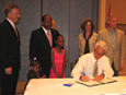 Governor Crist signs the Guardian Advocate bill.  Onlookers include, from left, Lt. Gov. Jeff Kottkamp, Rep. Curtis Richardson, and, right, Sen. Mike Fasano