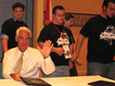 Governor Crist waves to the crowd after signing the Disability History and Awareness Bill.  Behind him is Florida Youth Council member and APD Communications Office employee Alex Brown