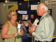 Ed Rousseau and Melanie Mowry Etters, both on the right, answer questions from Cafe attendees at the APD booth